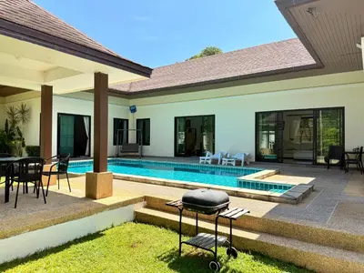 a house with a swimming pool and a grill at BlueElephant Villa NaiHarn in Rawai Beach