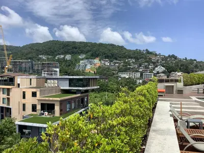 a view of a city with buildings and trees at Superb Apartment! 5 Mins to the Beach in Surin Beach