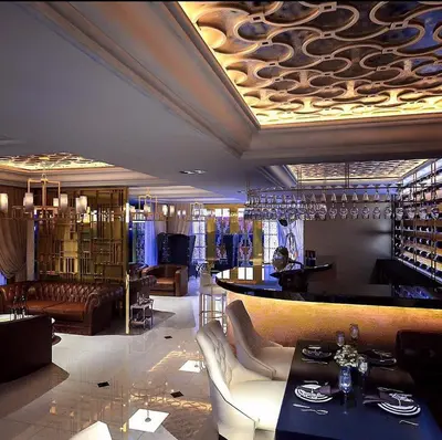 a restaurant with a bar with couches and a table at Superb Apartment! 5 Mins to the Beach in Surin Beach