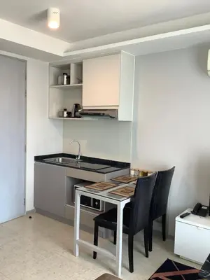 a kitchen with a table with chairs and a sink at Superb Apartment! 5 Mins to the Beach in Surin Beach