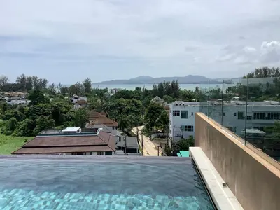 a swimming pool on the roof of a building at Superb Apartment! 5 Mins to the Beach in Surin Beach