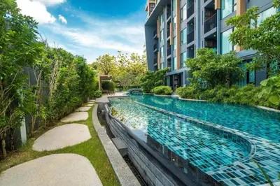 a swimming pool in the middle of a building at Modern 1 bedroom in Surin beach in Surin Beach