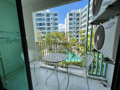 a balcony with a table and chairs on a balcony at Centrio 2 Bedrooms Condos in Town-Central Phuket in Ban Rangeng