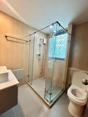 a bathroom with a shower and a toilet at Centrio 2 Bedrooms Condos in Town-Central Phuket in Ban Rangeng