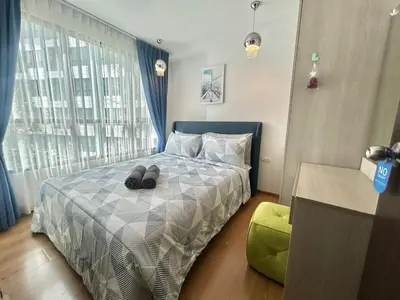 a bedroom with a bed with two slippers on it at Centrio 2 Bedrooms Condos in Town-Central Phuket in Ban Rangeng