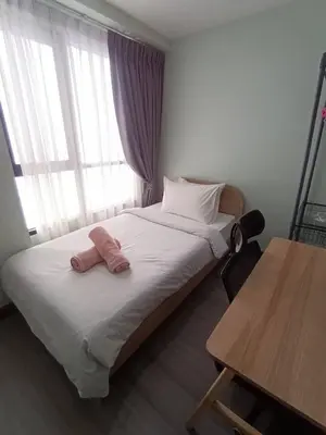 a bed with two pink towels on it in a room at Centrio 2 Bedrooms Condos in Town-Central Phuket in Ban Rangeng