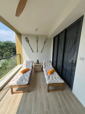 a living room with two white couches on a balcony at Lux apartment 100 sqm in Laguna in Bang Tao Beach
