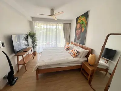 a bedroom with a bed and a painting on the wall at Lux apartment 100 sqm in Laguna in Bang Tao Beach