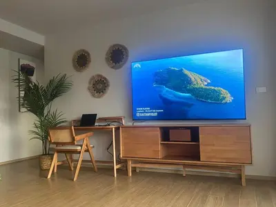 a living room with a flat screen tv on a entertainment center at Lux apartment 100 sqm in Laguna in Bang Tao Beach
