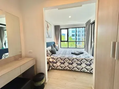 a bedroom with a bed and a window at 1 Bedroom Condos Close to Shopping Malls in Ban Rangeng
