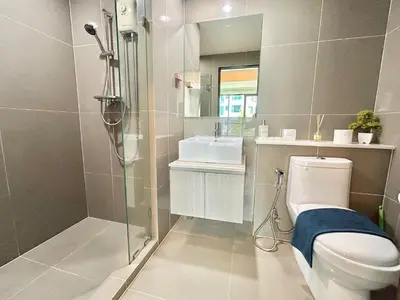 a bathroom with a shower and a toilet and a sink at 1 Bedroom Condos Close to Shopping Malls in Ban Rangeng