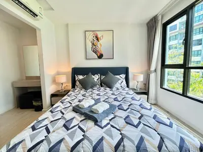 a bedroom with a large bed with two pillows on it at 1 Bedroom Condos Close to Shopping Malls in Ban Rangeng