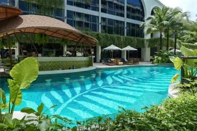 a swimming pool in front of a building at Amazing La Green 10 min walk to Layan Beach in Layan Beach