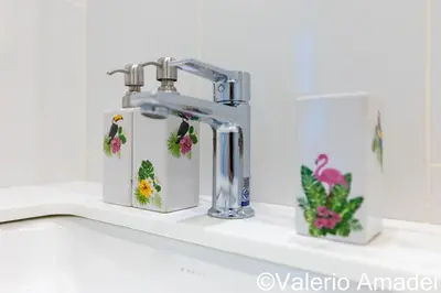 two water faucets sitting on a bathroom sink at OMNIAPHUKET - Pool View Apartment at Phuket Villa Patong Beach in Patong Beach