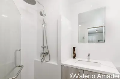 a bathroom with a shower and a sink and a mirror at OMNIAPHUKET - Pool View Apartment at Phuket Villa Patong Beach in Patong Beach