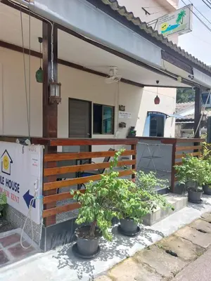 a house with potted plants sitting outside of it at Smile House Apartment 24 in Karon Beach