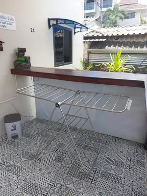 a metal shelf in a room with a window at Smile House Apartment 24 in Karon Beach