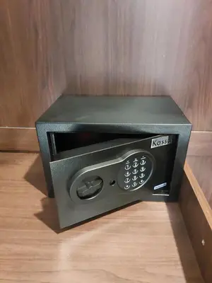 a black microwave oven sitting on a wooden floor at Smile House Apartment 24 in Karon Beach