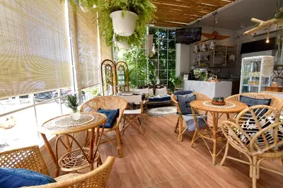 a restaurant with tables and chairs in a room at Chill House at Naiyang in Nai Yang Beach