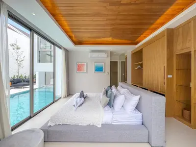 a living room with a couch and a pool at Luxurious 3-Bedroom Villa with Private Pool Lux Pride 4 L10 Phuket in Bang Tao Beach