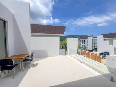a balcony with a table and chairs on a building at Luxurious 3-Bedroom Villa with Private Pool Lux Pride 4 L10 Phuket in Bang Tao Beach