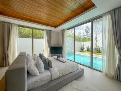 a bedroom with a large bed and a swimming pool at Luxurious 3-Bedroom Villa with Private Pool Lux Pride 4 L10 Phuket in Bang Tao Beach