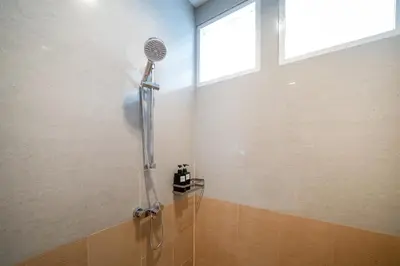 a shower with a shower head in a bathroom at 7BR Grand Pool Villa in heart Patong in Patong Beach