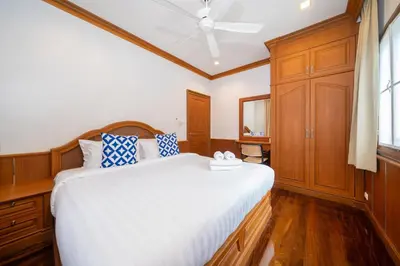 a bedroom with a bed and a ceiling fan at 7BR Grand Pool Villa in heart Patong in Patong Beach