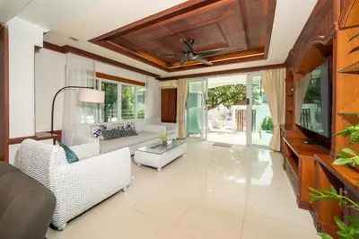 a living room with white furniture and a ceiling fan at 7BR Grand Pool Villa in heart Patong in Patong Beach