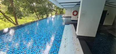 a large swimming pool with blue tiles in a building at Studio in Boat Avenue in Bang Tao Beach