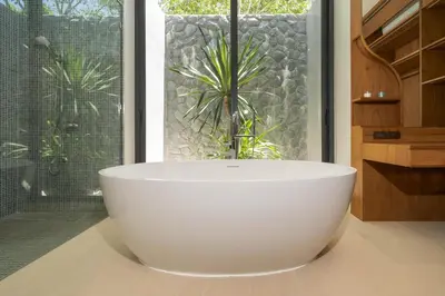 a white bath tub in a bathroom with a window at Bougainvillea Luxury Pool Villas in Ban Pak Lak