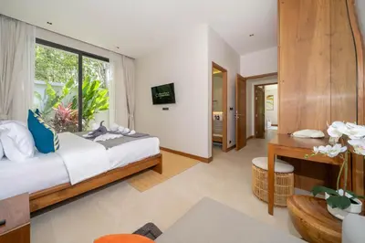 a bedroom with a bed and a large window at Bougainvillea Luxury Pool Villas in Ban Pak Lak