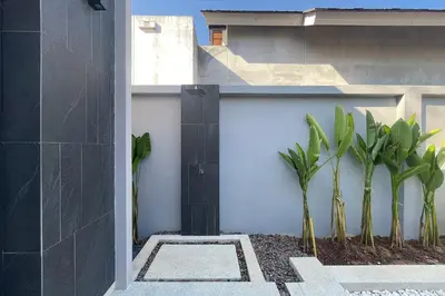 a house with plants on the side of it at Bougainvillea Luxury Pool Villas in Ban Pak Lak