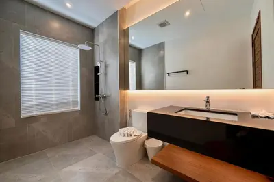 a bathroom with a sink and a toilet at Bougainvillea Luxury Pool Villas in Ban Pak Lak