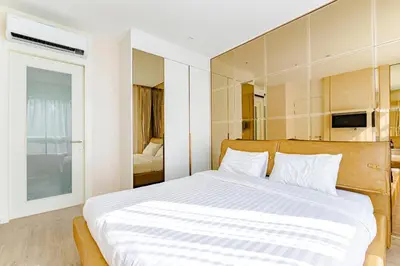 a bedroom with a large bed with white sheets at Luxury Condo The City Phuket in Heart of Phuket in Kathu