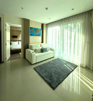 a living room with a white couch and a rug at Luxury Condo The City Phuket in Heart of Phuket in Kathu