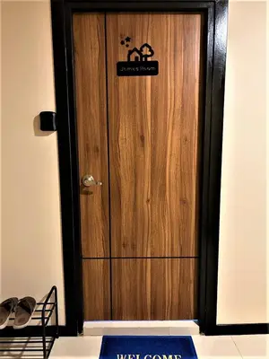 a wooden door with a sign on it at Rawai Beach - 1 BR Cozy Condo in Nai Harn Beach