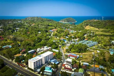 an aerial view of a city and the ocean at Rawai Beach - 1 BR Cozy Condo in Nai Harn Beach