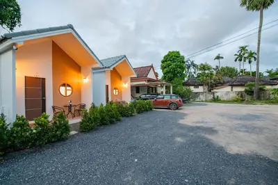 a house with a car parked in the driveway at Sachi Minimal House Bangtao Beach - Near Muay Thai Gym in Surin Beach