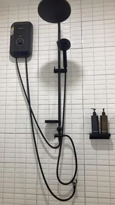 a shower head on a wall in a bathroom at Sachi Minimal House Bangtao Beach - Near Muay Thai Gym in Surin Beach