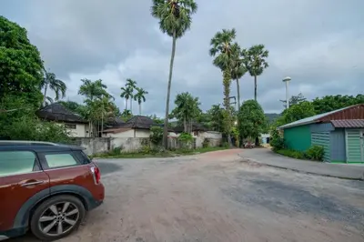 a car parked on the side of a dirt road at Sachi Minimal House Bangtao Beach - Near Muay Thai Gym in Surin Beach