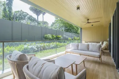 a living room with a couch and chairs and a table at Laguna Beachfront 3BR Cozy Condo in Bang Tao Beach