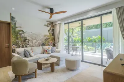 a living room with a couch and a table at Laguna Beachfront 3BR Cozy Condo in Bang Tao Beach