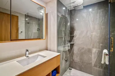 a bathroom with a sink and a shower at Laguna Beachside Block 3 by Banyan Living in Ban Thalat Choeng Thale