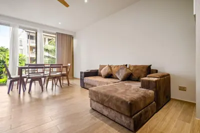 a living room with a couch and a table at Laguna Beachside Block 3 by Banyan Living in Ban Thalat Choeng Thale