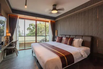 a bedroom with a large bed and a large window at Syama V Beachfront Resort Ao Nang Krabi, Aspira Collection - Adults Only in Ao Nang Beach