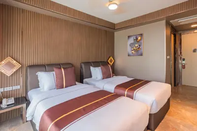 two beds in a hotel room next to each other at Syama V Beachfront Resort Ao Nang Krabi, Aspira Collection - Adults Only in Ao Nang Beach