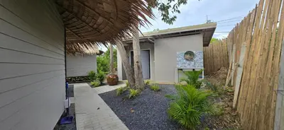 a backyard with a fence and a house at Krabi Sea View Orchid Beach room in Krabi town