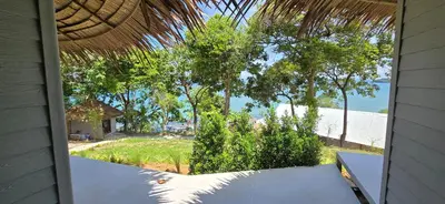 a view of a beach from the porch of a house at Krabi Sea View Orchid Beach room in Krabi town