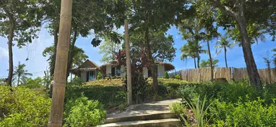 a house on a hill with trees and a path at Krabi Sea View Orchid Beach room in Krabi town